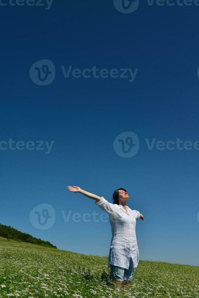 Young happy woman in green field photo