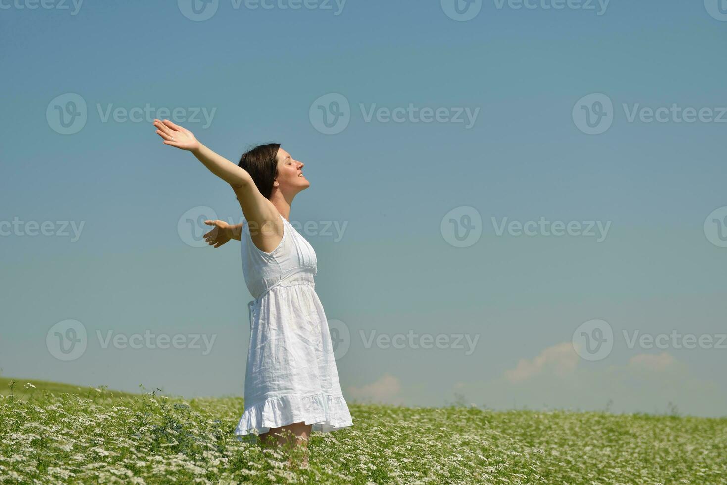 Young happy woman in green field photo