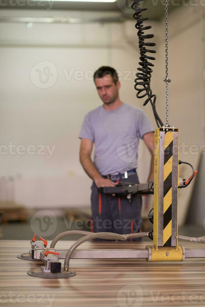worker in a factory of wooden furniture photo