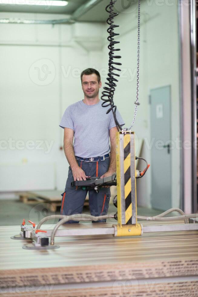 worker in a factory of wooden furniture photo