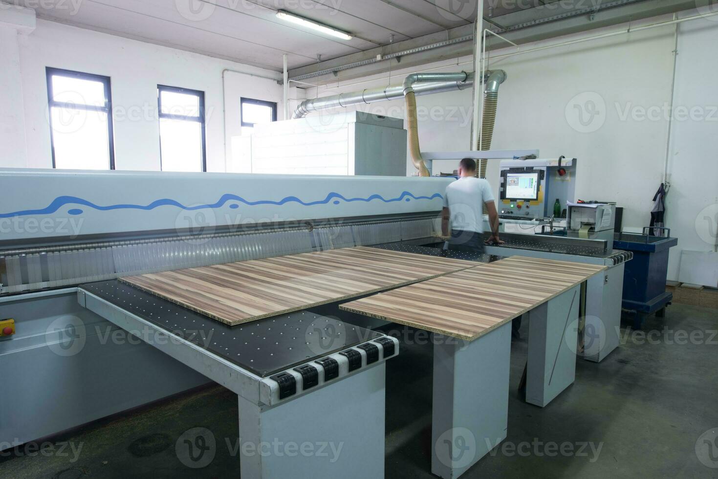 worker in a factory of wooden furniture photo