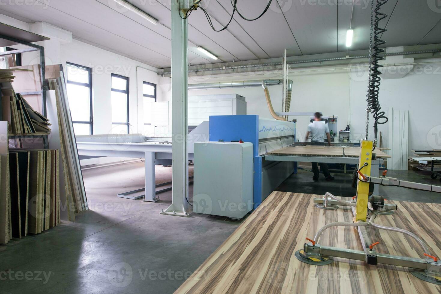worker in a factory of wooden furniture photo