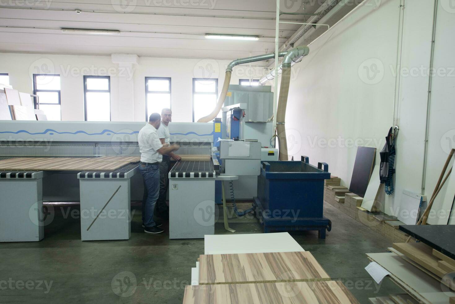 workers in a factory of wooden furniture photo