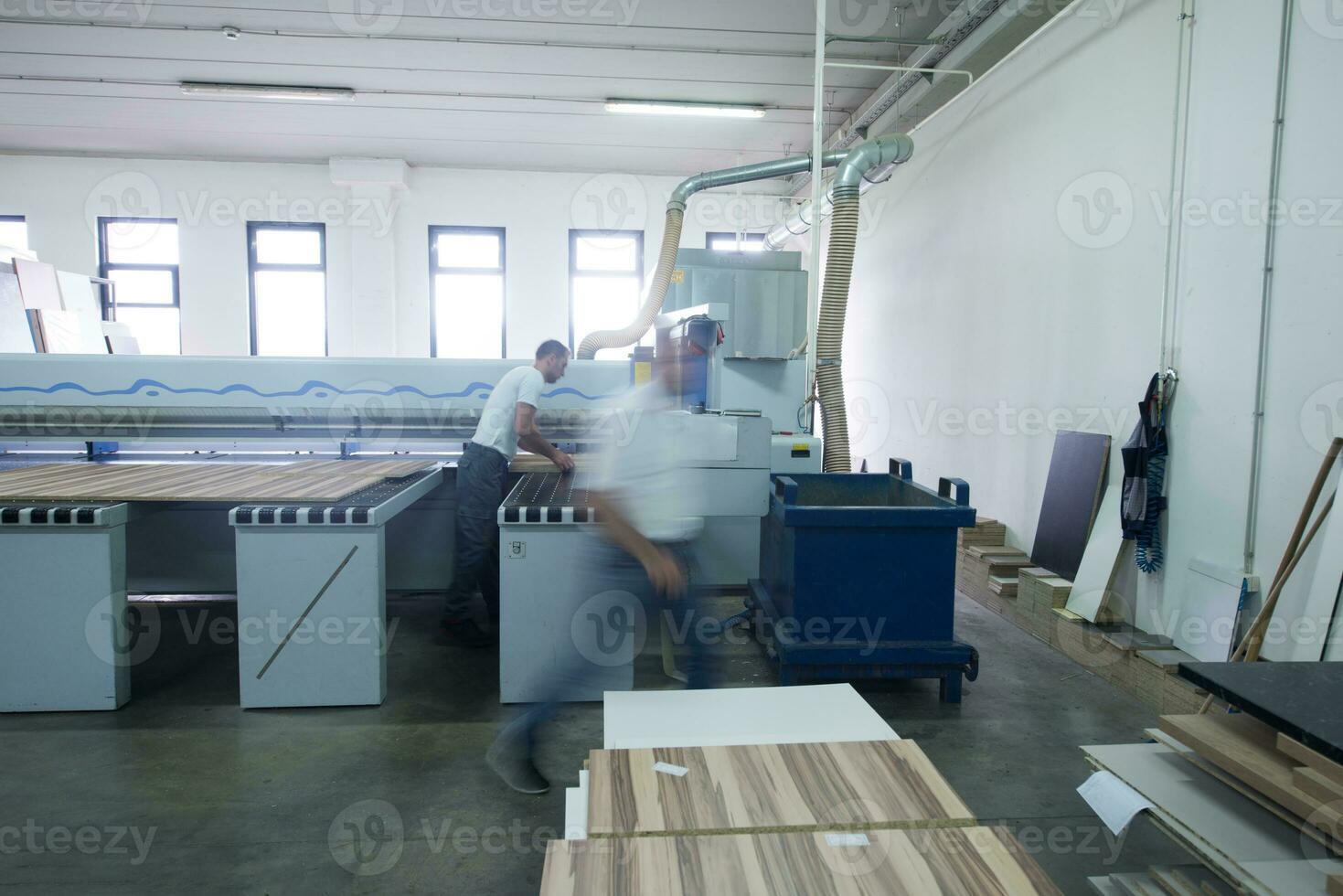 workers in a factory of wooden furniture photo