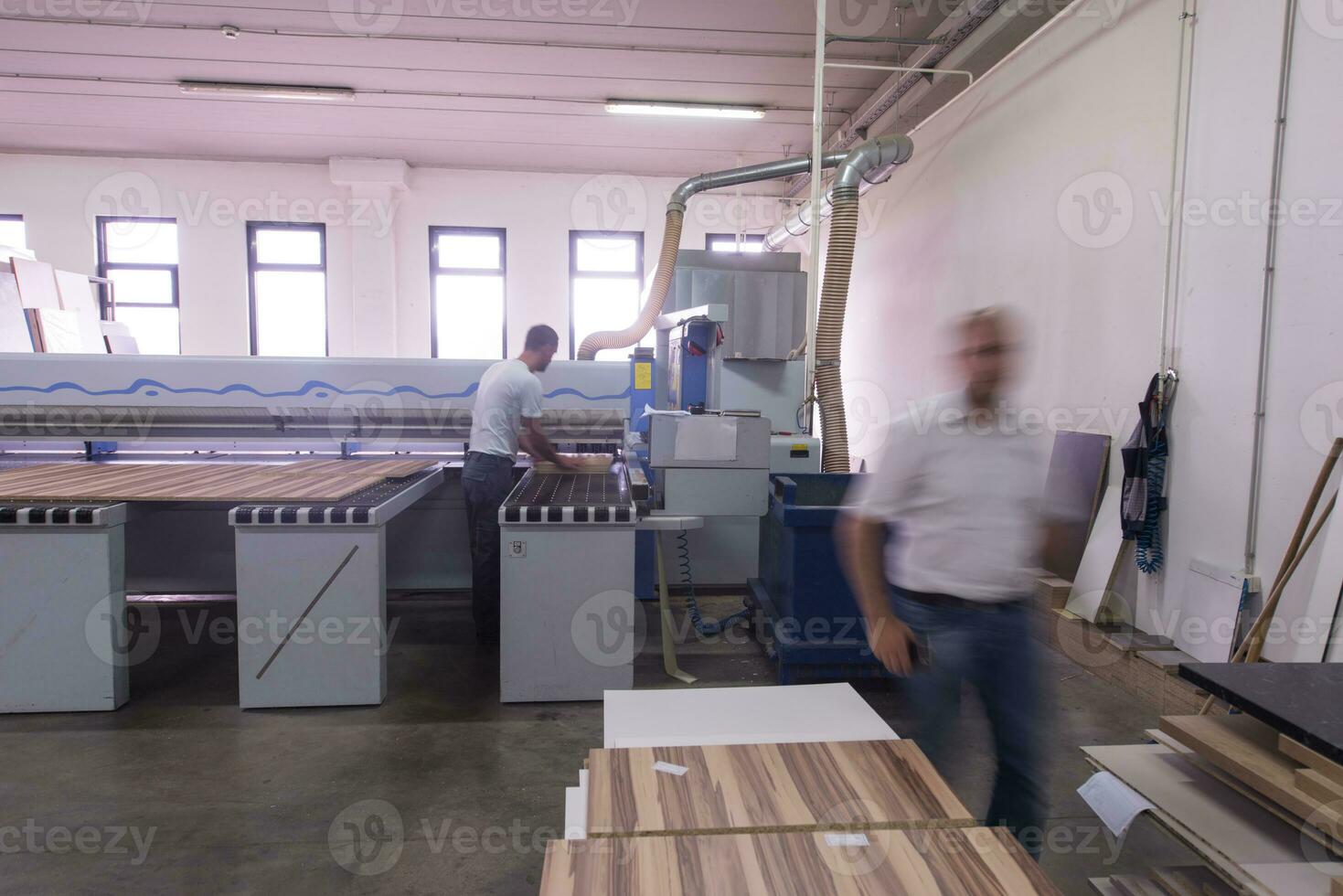 workers in a factory of wooden furniture photo