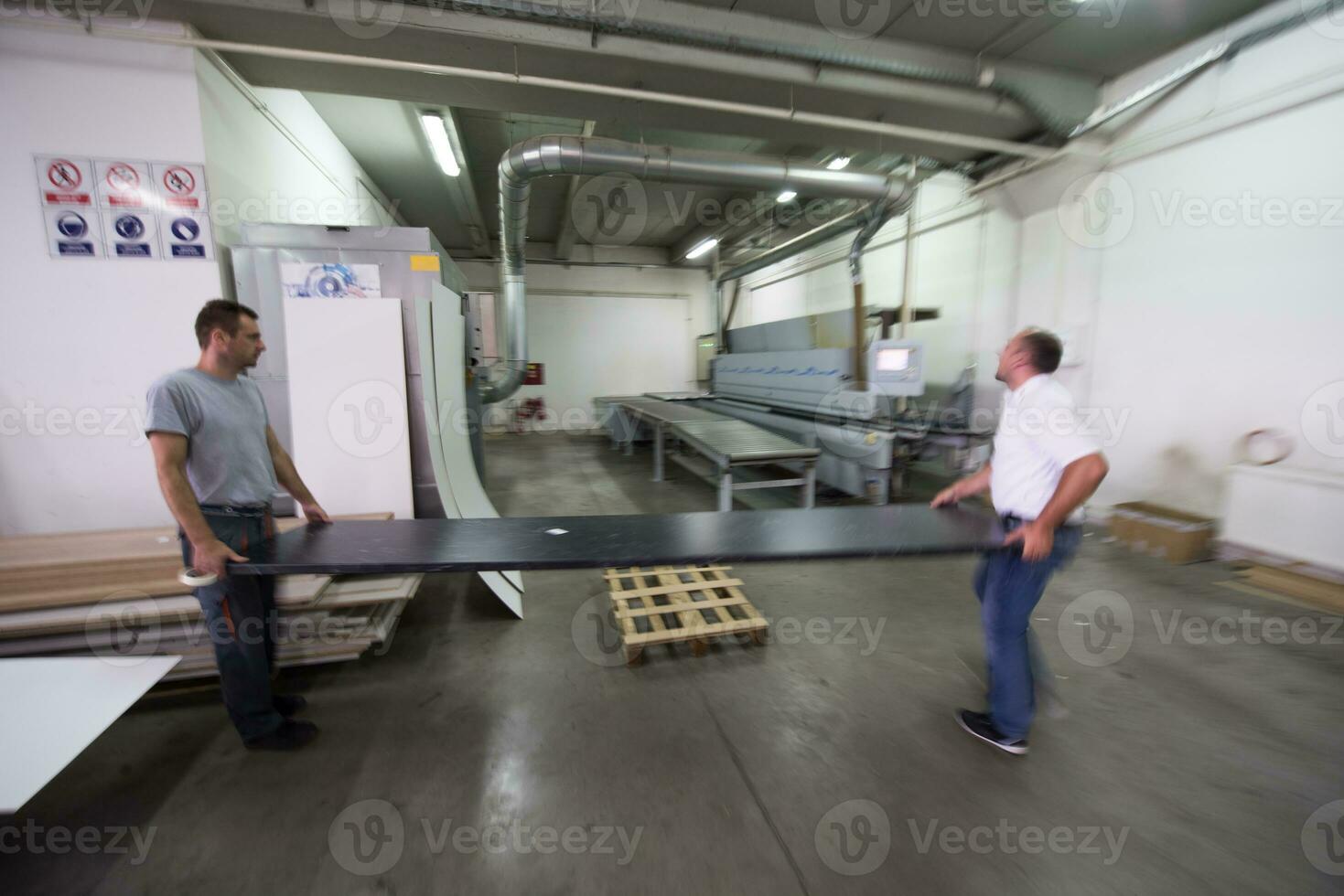 workers in a factory of wooden furniture photo