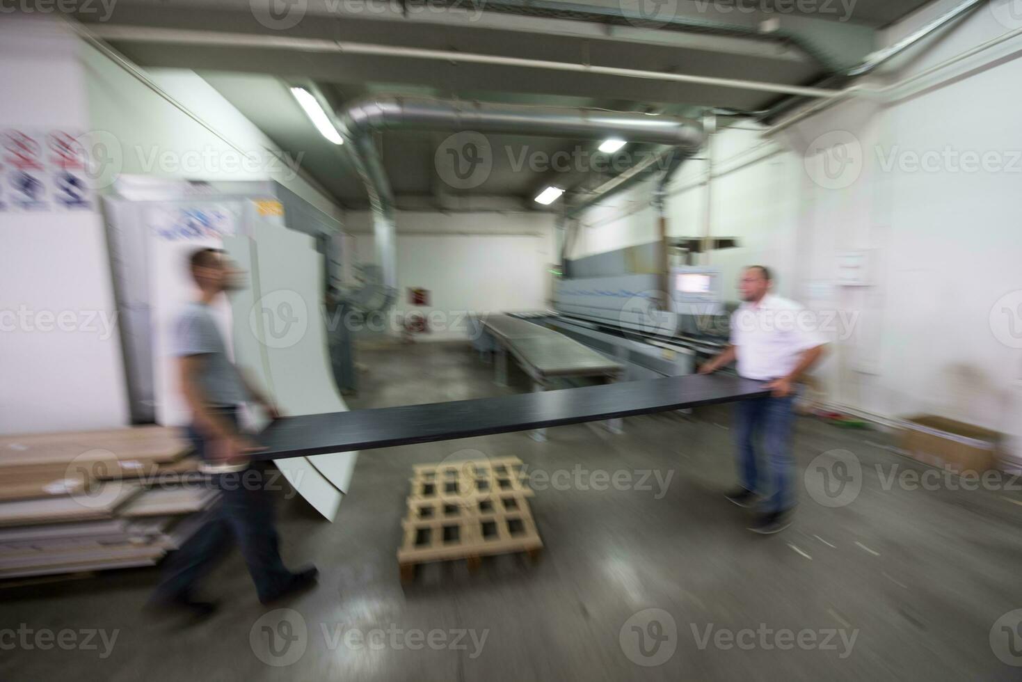 workers in a factory of wooden furniture photo