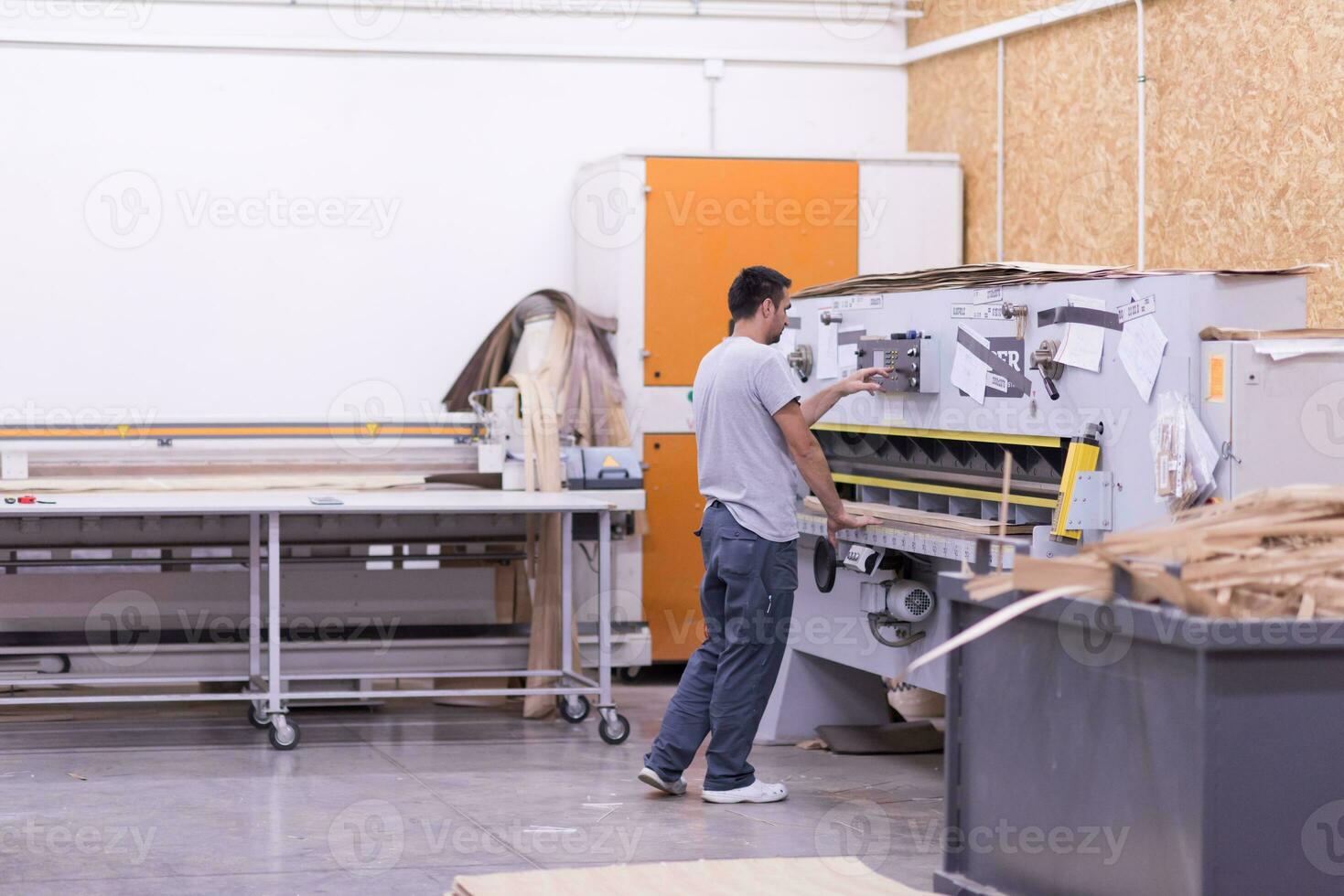 worker in a factory of wooden furniture photo