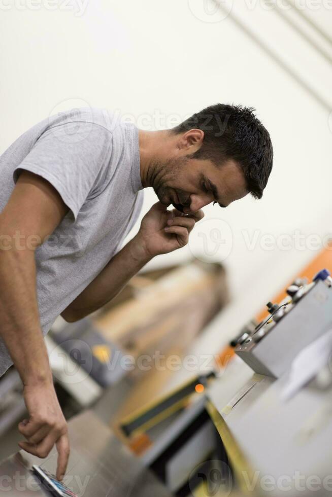 engineer in front of wood cutting machine photo