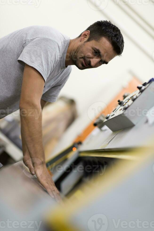 worker in a factory of wooden furniture photo