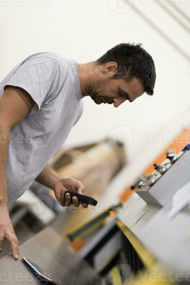 engineer in front of wood cutting machine photo