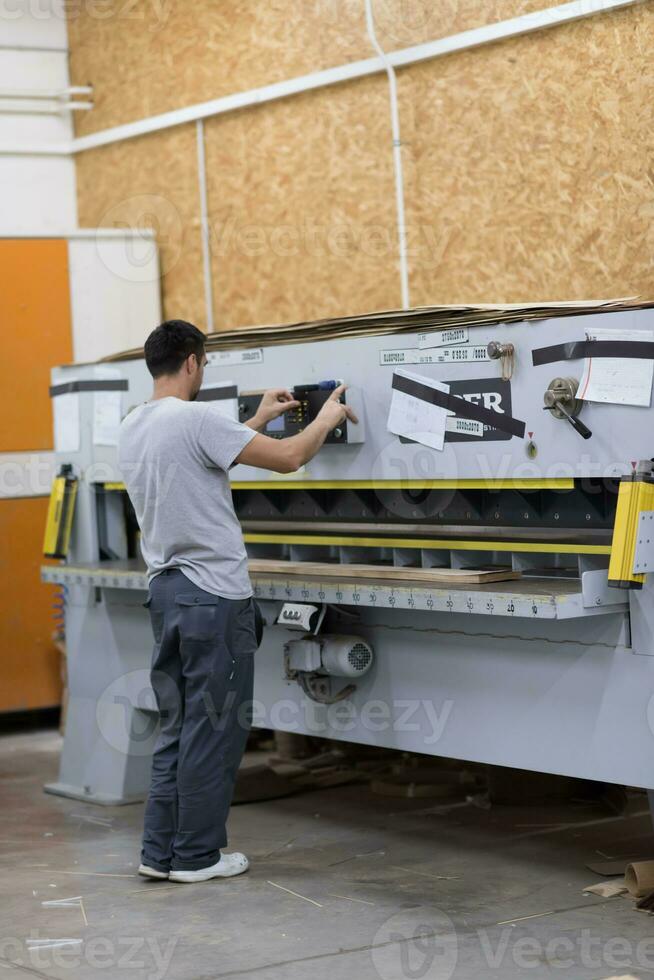 worker in a factory of wooden furniture photo