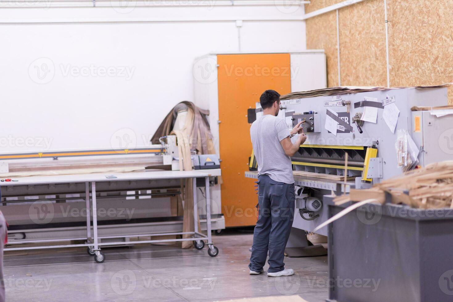 worker in a factory of wooden furniture photo