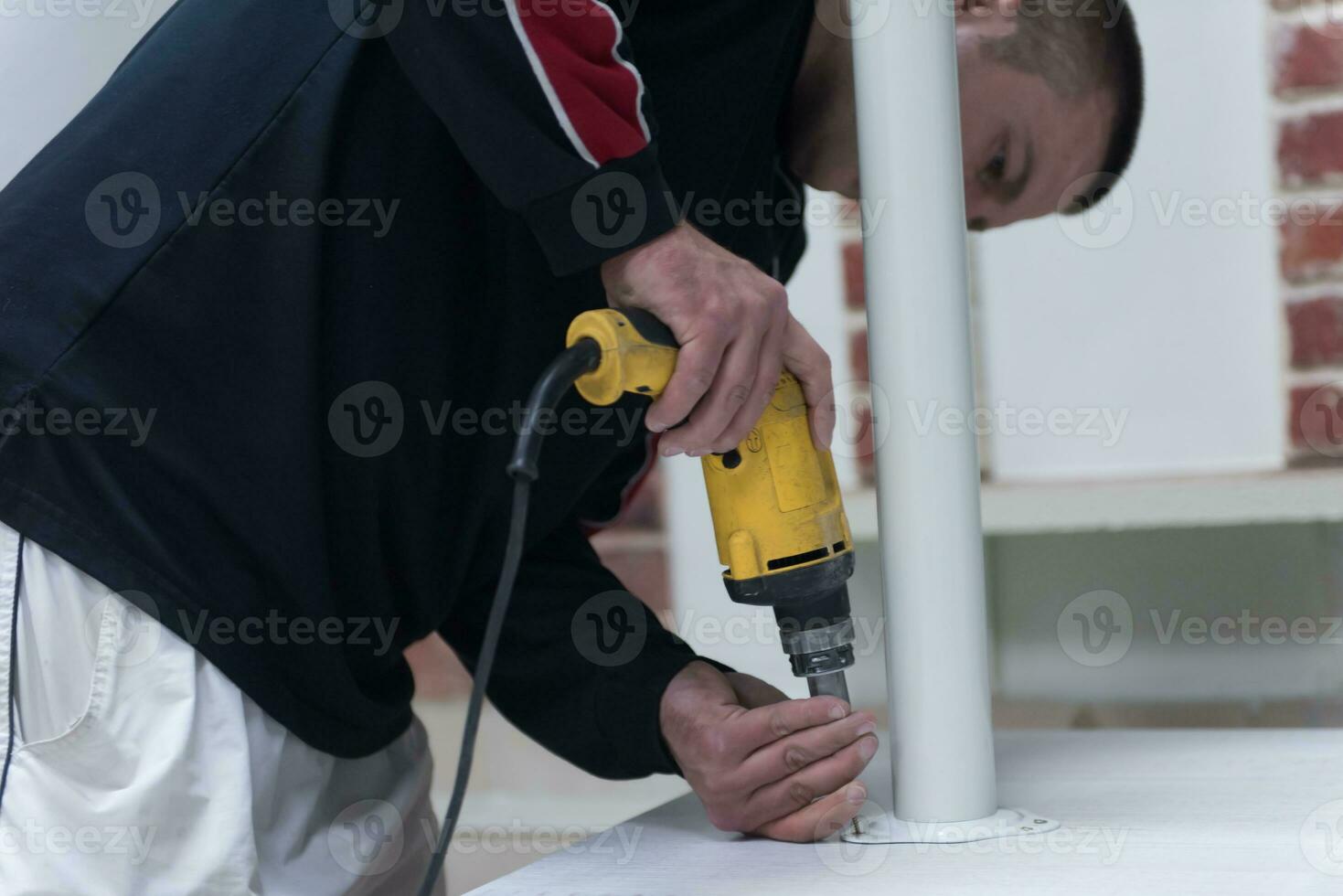 repairman working with drilling machine photo