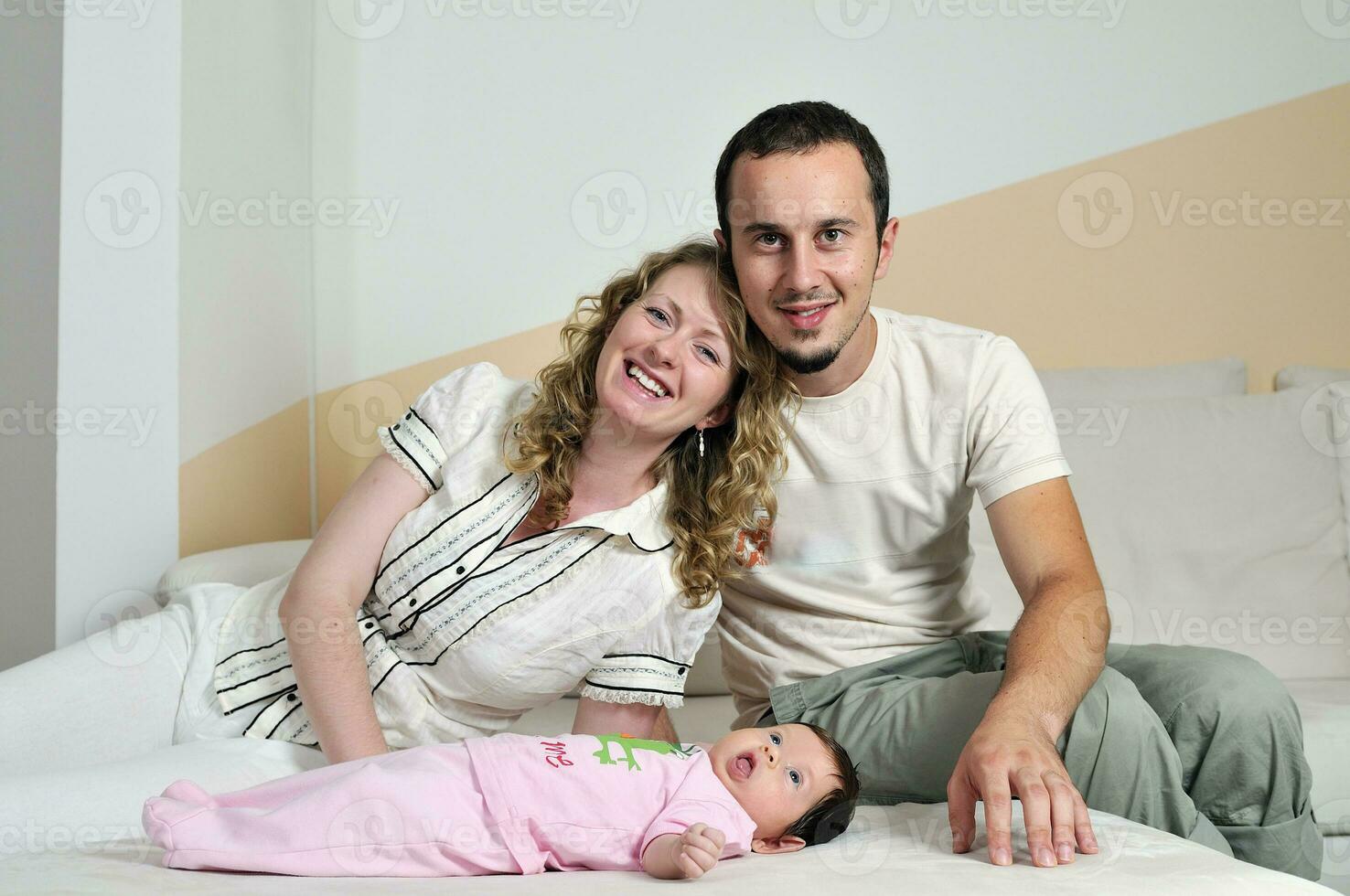 indoor portrait with happy young famil and  cute little babby photo