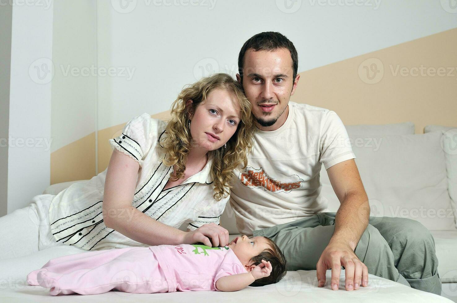 indoor portrait with happy young famil and  cute little babby photo