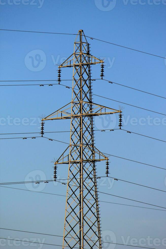 Electrical pylon by sunset photo