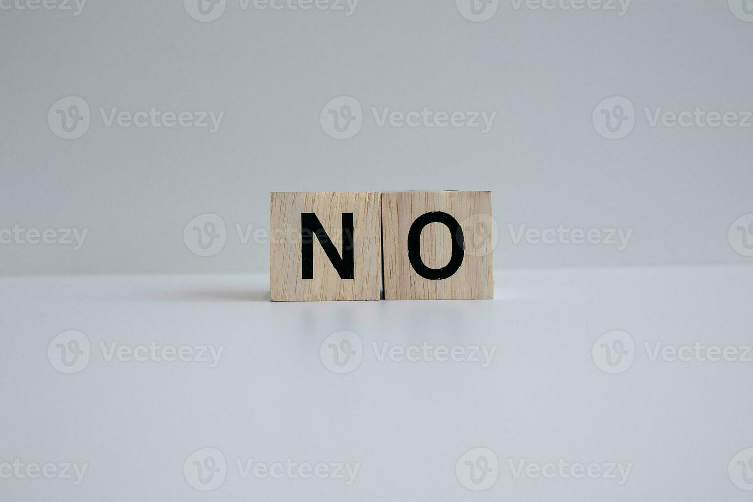 Wooden blocks form the text NO against a white background. photo