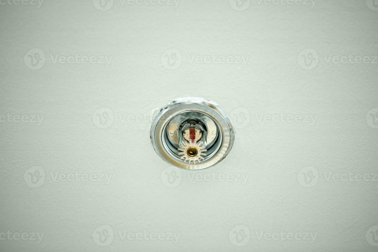 Sprinkler mounted on the ceiling with a white background. Close-up. photo