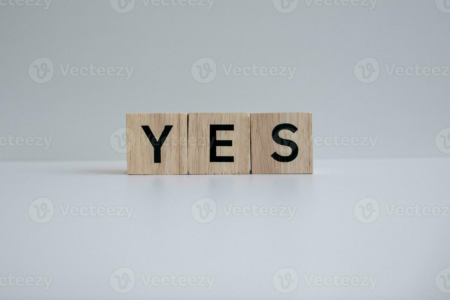 Wooden blocks form the text YES against a white background. photo