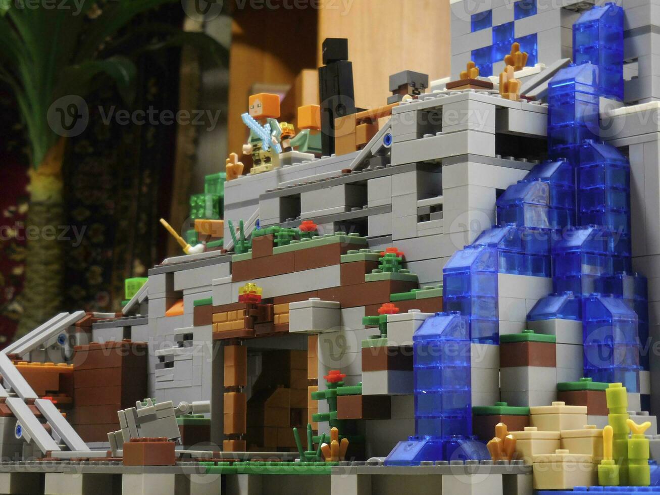 big lego constructor in the style of minecraft, adventure on mountain with waterfall photo