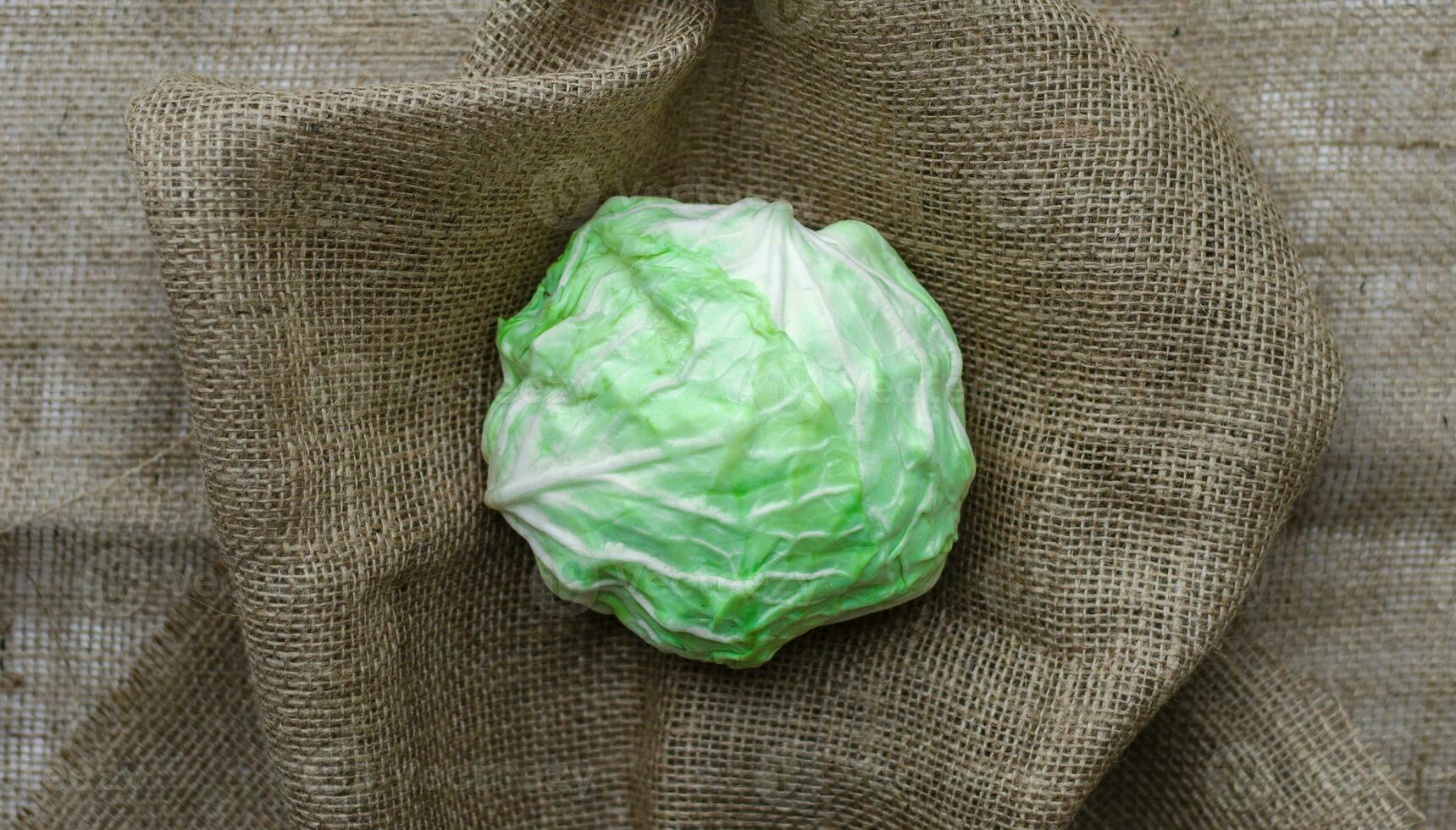 fresh cabbage on a brown fabric background photo