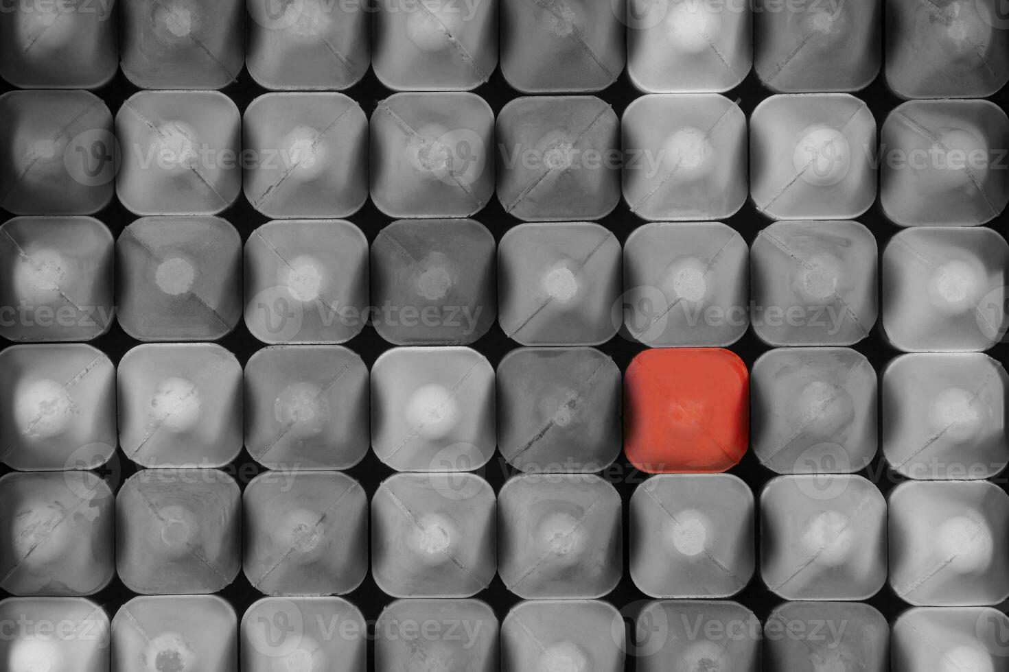 Looking Down on a Box of Gray Chalk with One Red Piece photo
