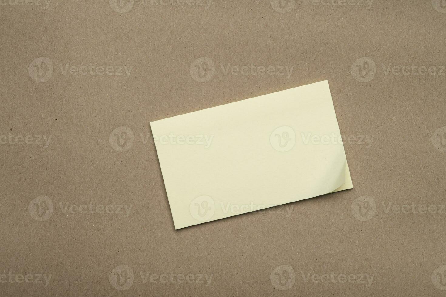 Yello Stick Note on Brown Craft Paper Background photo