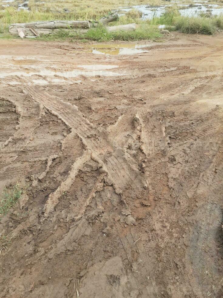 the road is made of the mud. it is a lot of dirt. the road is covered with mud. photo