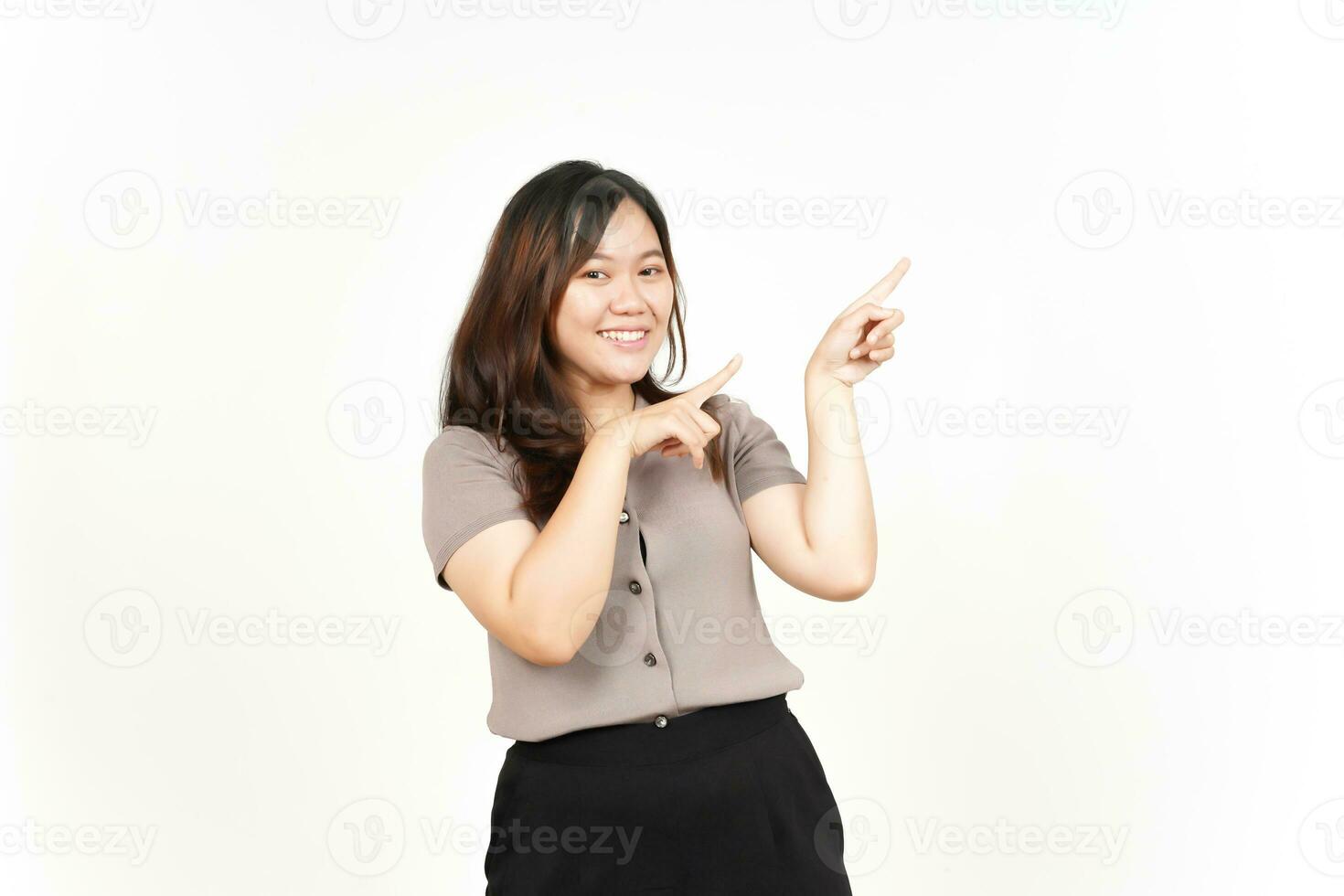 Showing Product and Pointing Blank Side using forefinger Of Beautiful Asian Woman Isolated On White Background photo
