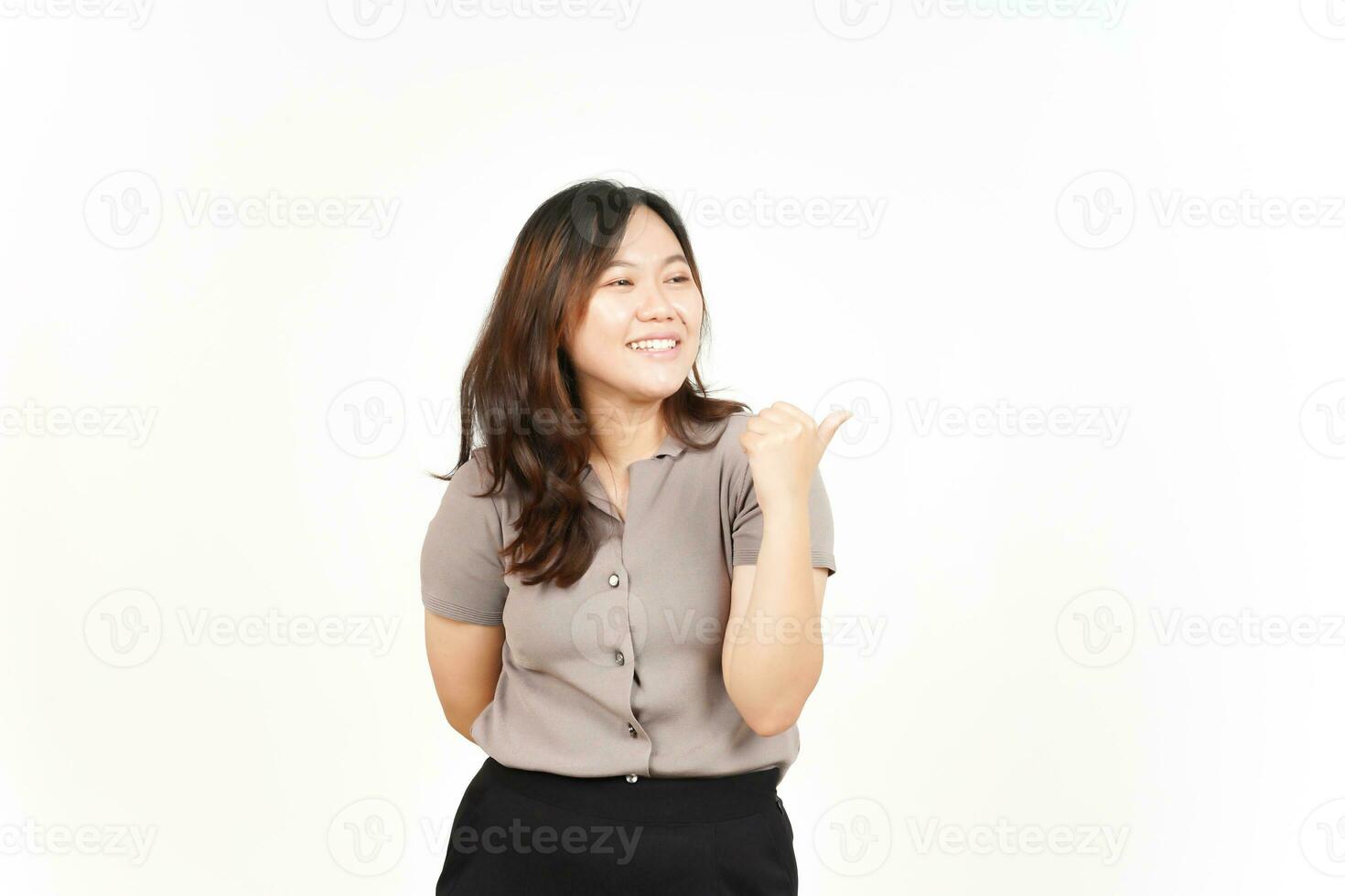 Presenting and Pointing Side Product Using Thumb Of Beautiful Asian Woman Isolated On White photo