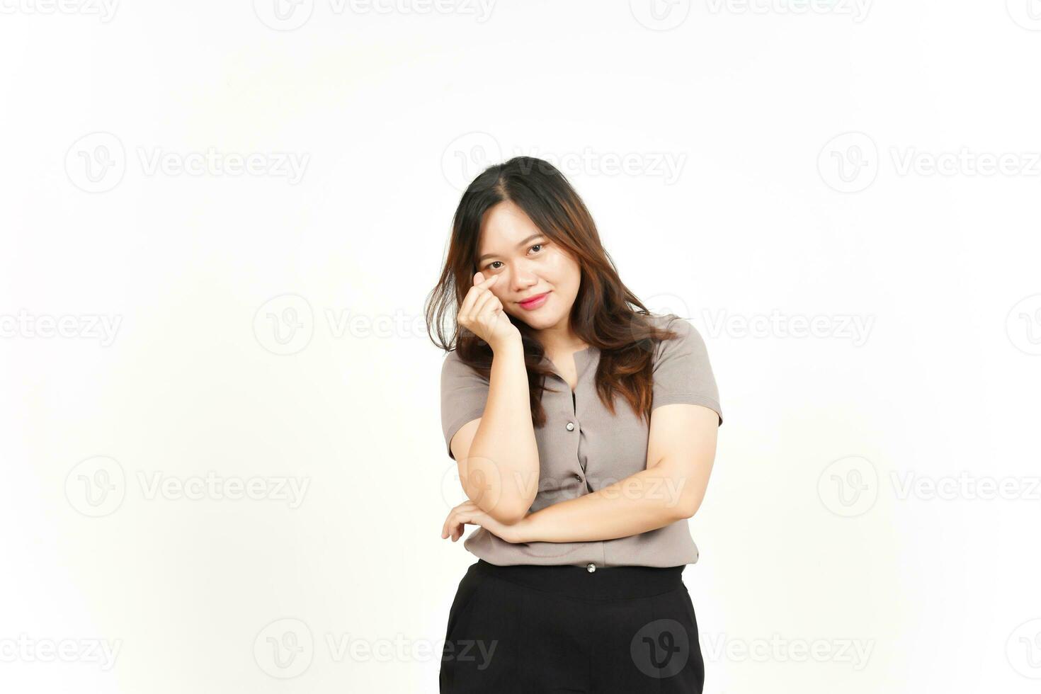 An Asian woman is showing the Korean love sign with a white background, smiling brightly photo