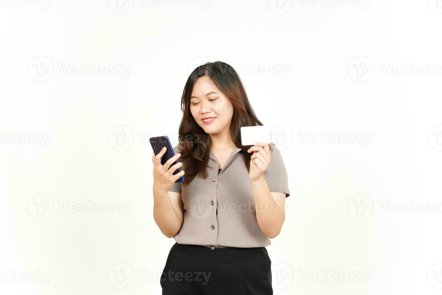 Using Smartphone and Holding Blank Credit Card Of Beautiful Asian Woman Isolated On White Background photo