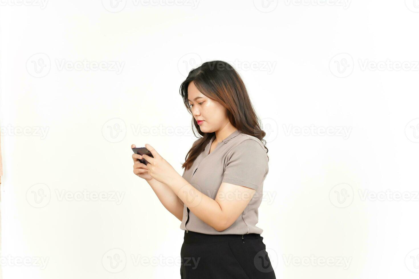 Playing Mobile Game on Smartphone Of Beautiful Asian Woman Isolated On White Background photo