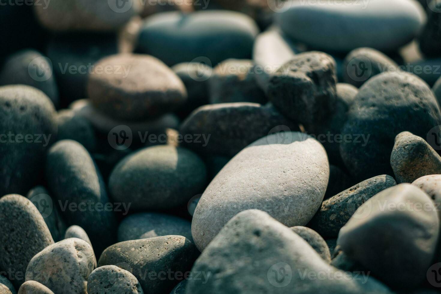 Background wet pebbles. The texture of polished sea stones. Close-up photo