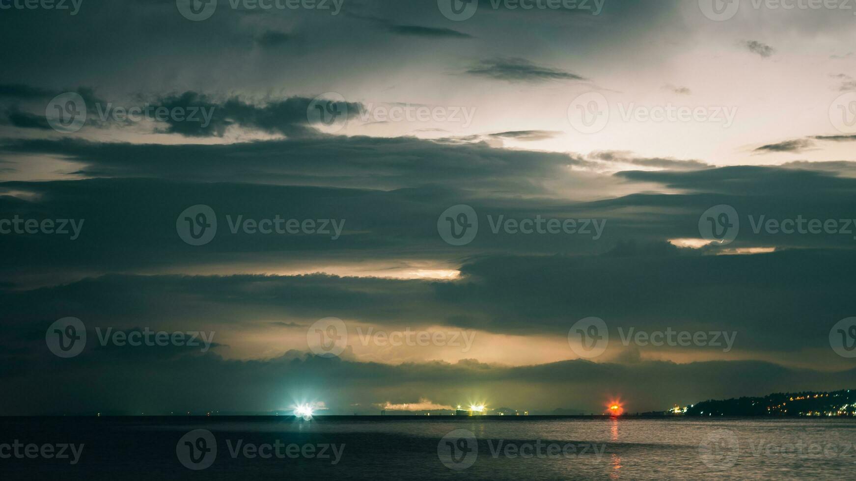 Epic photo of the sky over the sea with lightning in the clouds. Spectacular nature show. Long exposure photography, night landscape