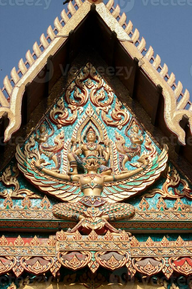 Bas-relief sculpture in the shape of Garuda is a Thai art, an animal in Thai literature, a bird's-eye view, a delicate art created by Thai artists in religious posts. photo
