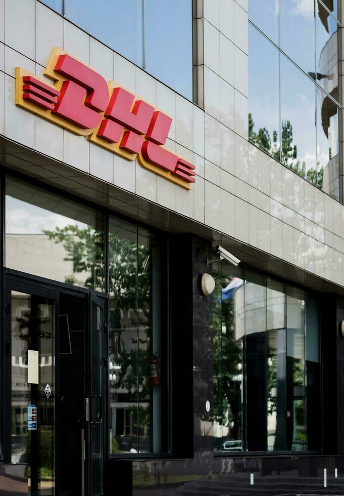 Minsk, Belarus, August 2023 - facade of the building with a DHL sign. photo