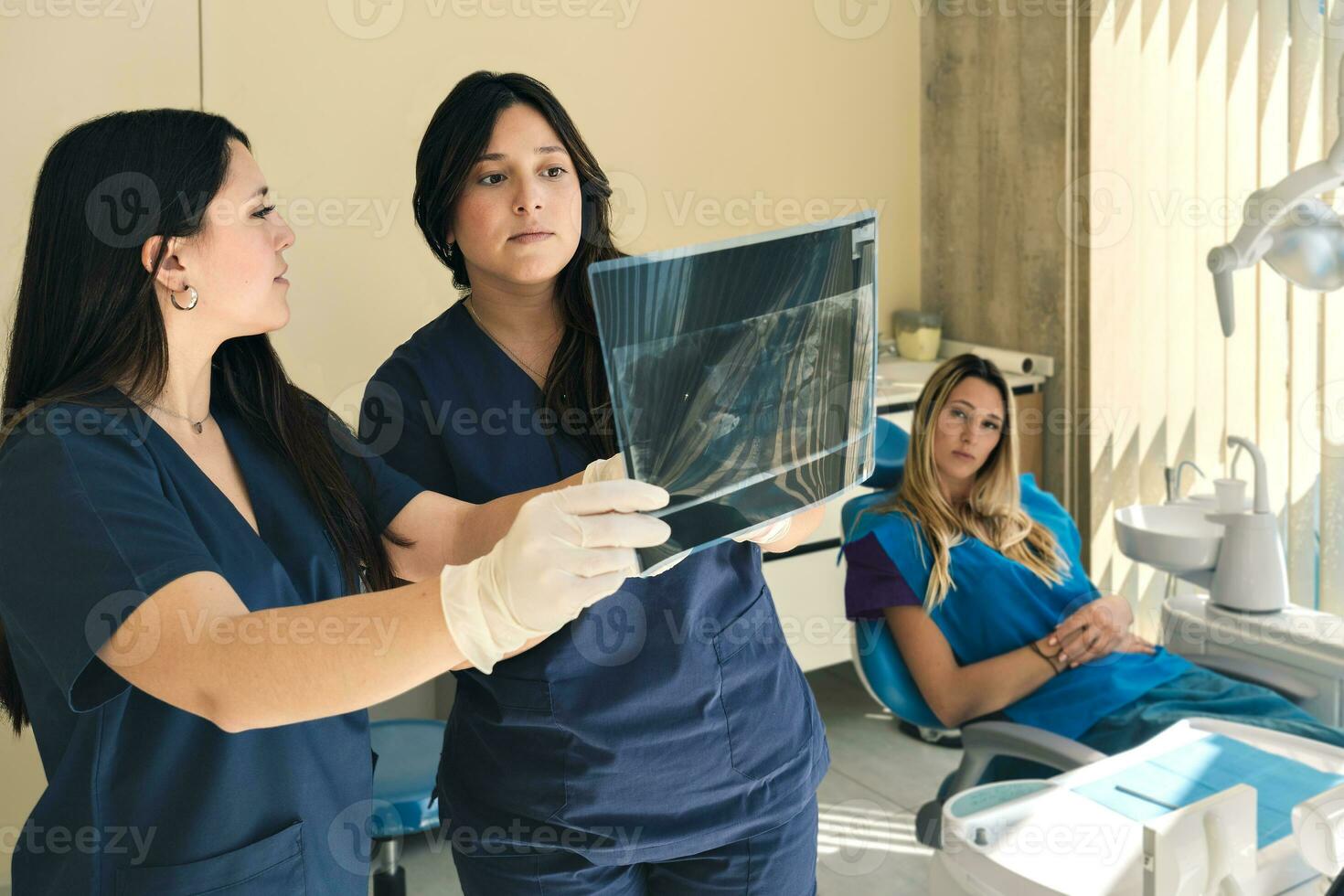 Medical Team Examining Patient's X-ray Image in Dental Clinic. photo