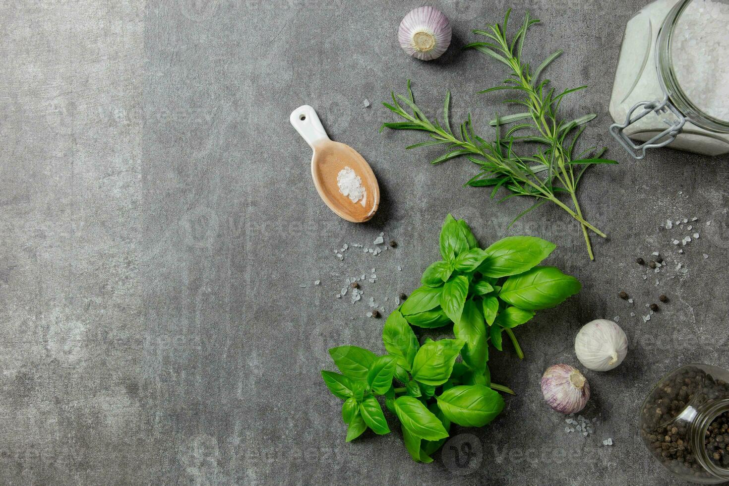 Selection of spices herbs and greens. Ingredients for cooking, food background on dark gray background. Top view. Copy space. photo