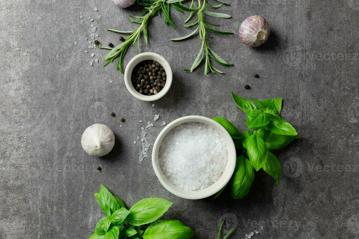 Selection of spices herbs and greens. Ingredients for cooking, food background on dark gray background. Top view. photo