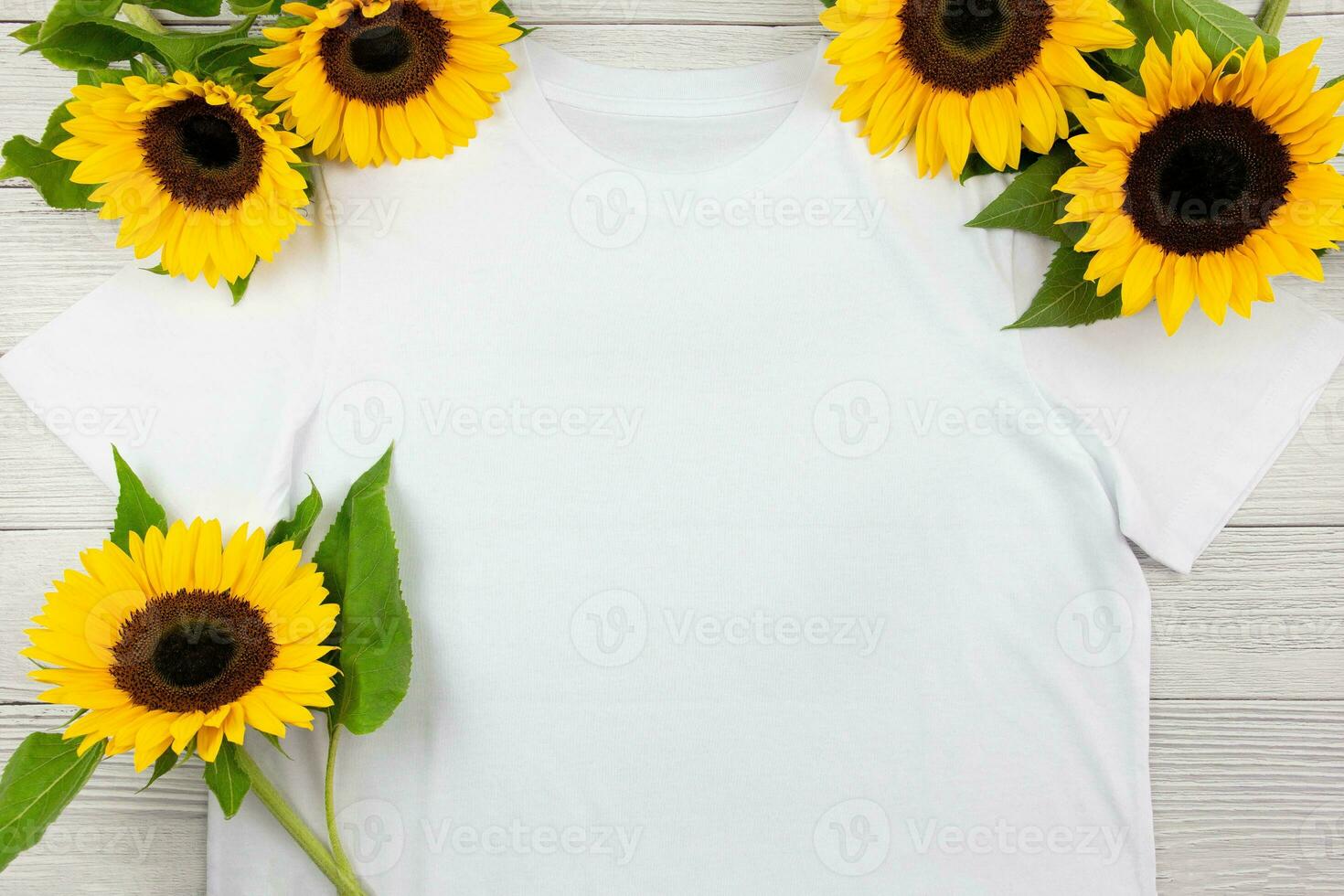White womens cotton T Shirt mockup with sunflowers on white wooden background. Design t shirt template, print presentation mock up. Top view flat lay. photo