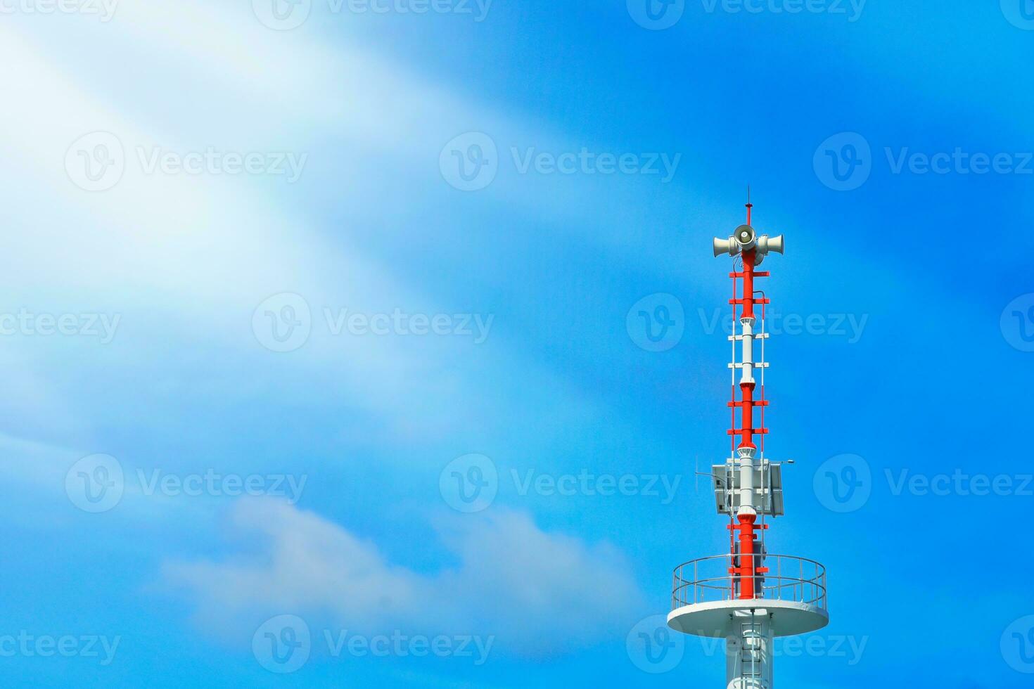 Announcement pole with horn speaker, broadcast tower and solar cell Morning clear sky background with bright sunlight. photo