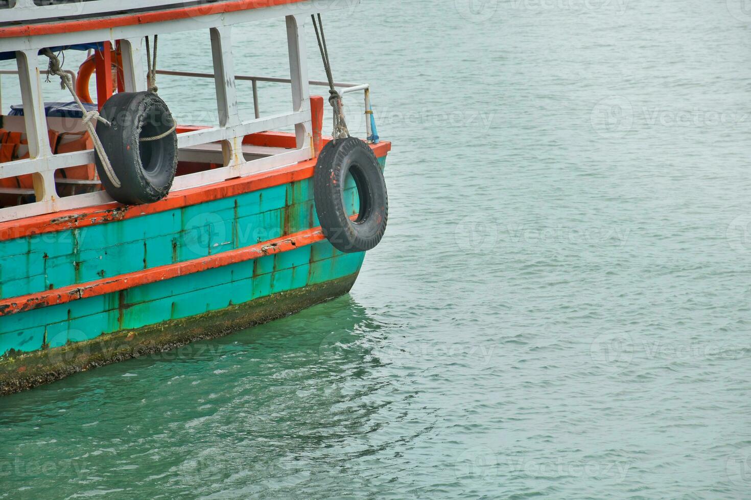 Passenger boat moored on the sea With bright colors and boats with beautiful classic patterns, the sea has beautiful gradient colors,Safe boat travel. photo