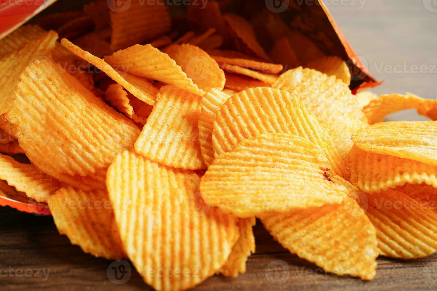 Potato chips in open bag, delicious BBQ seasoning spicy for crips, thin slice deep fried snack fast food. photo