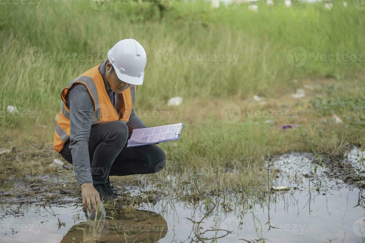 Environmental engineers inspect water quality,Bring water to the lab for testing,Check the mineral content in water and soil,Check for contaminants in water sources. photo