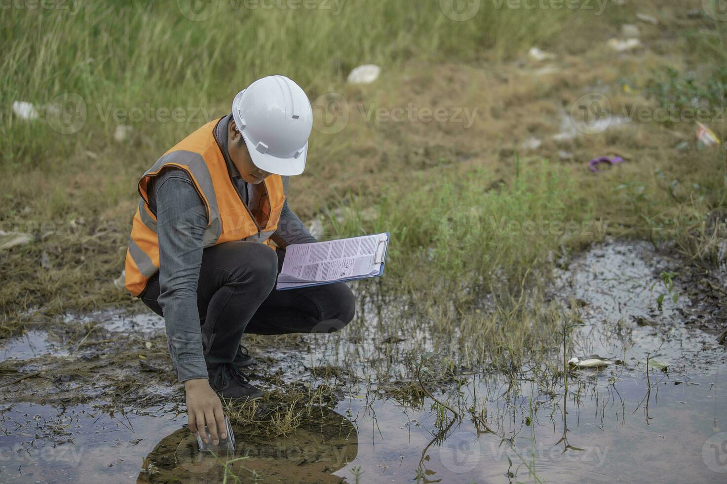 Environmental engineers inspect water quality,Bring water to the lab for testing,Check the mineral content in water and soil,Check for contaminants in water sources. photo