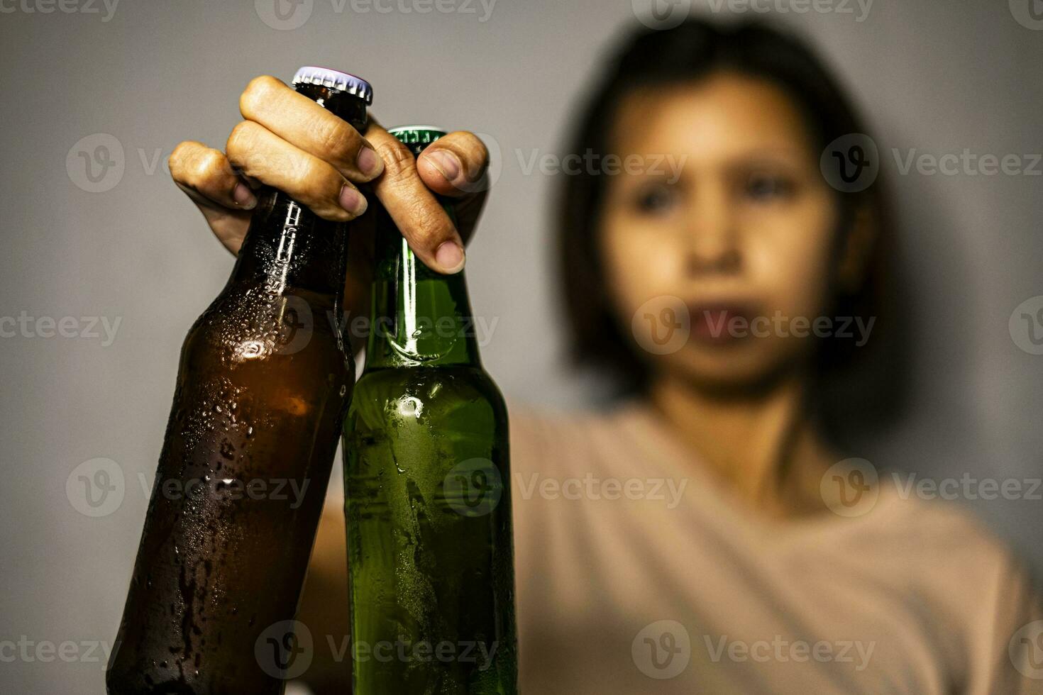 Hand Holding Up The Bottles Of Beer photo