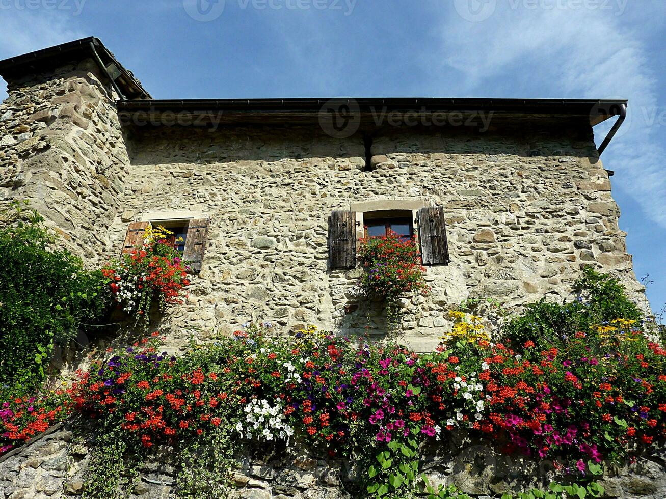 Old house made of bricks with flowers photo