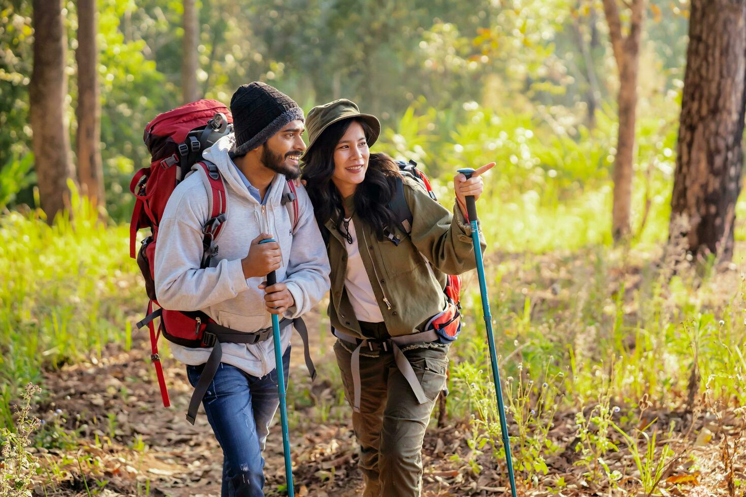Couple travelers with backpacks relaxing on mountain photo